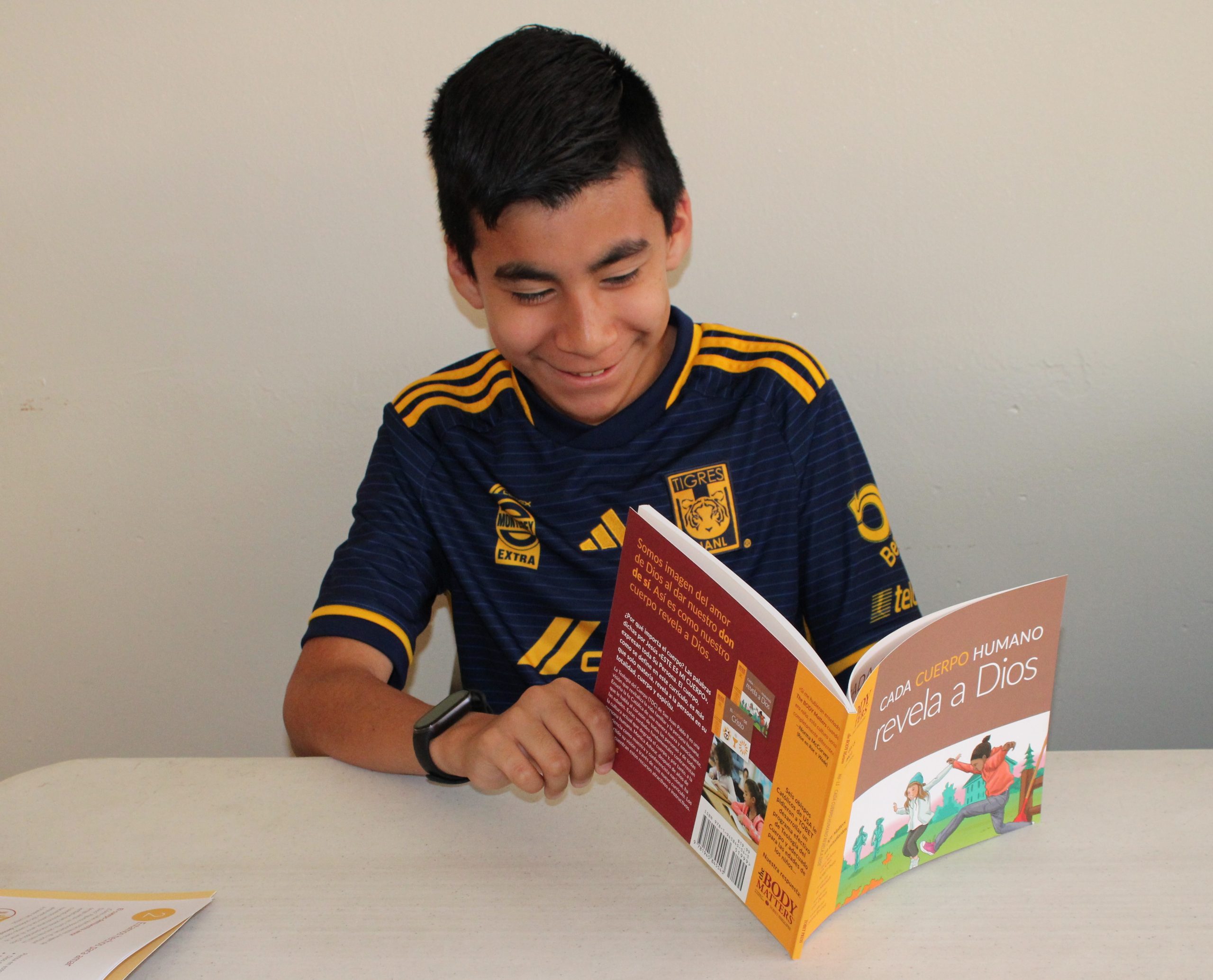 Spanish-speaking boy reading TBM