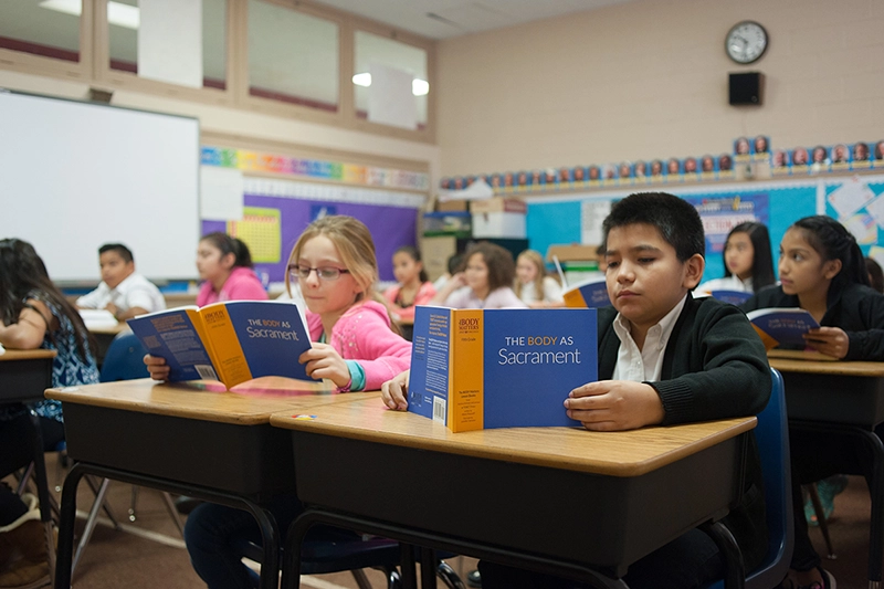 TBM children reading lesson books in classroom 800x533